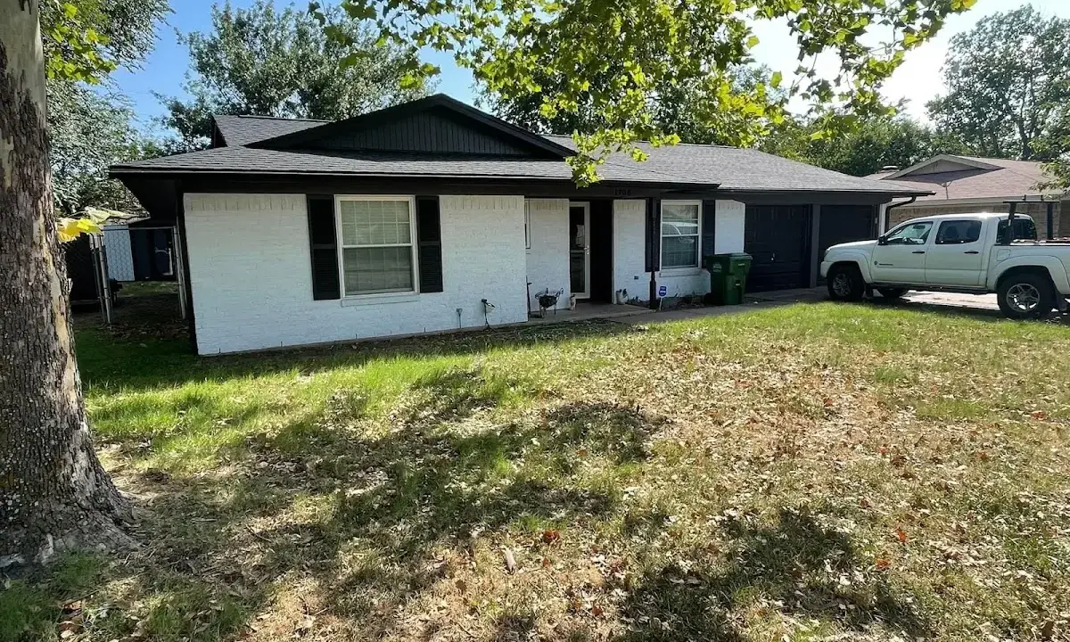 Professional roofing crew working on a residential roof in Faribault